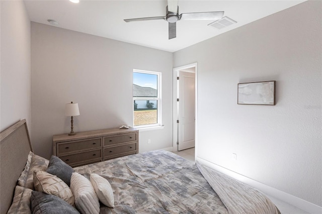 bedroom featuring a ceiling fan, visible vents, and baseboards