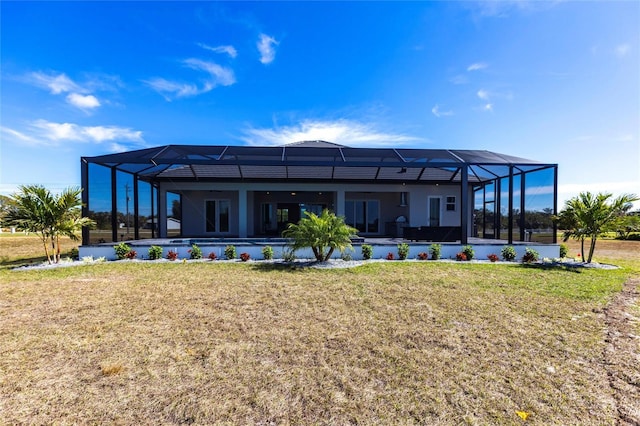 back of property featuring glass enclosure, a lawn, and an outdoor pool