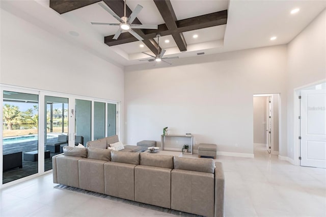 living room featuring beam ceiling, coffered ceiling, a towering ceiling, and baseboards