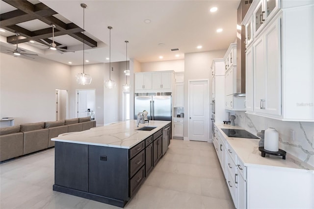 kitchen with coffered ceiling, white cabinets, open floor plan, appliances with stainless steel finishes, and tasteful backsplash