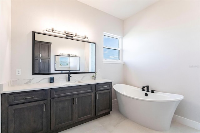 bathroom featuring a freestanding bath and vanity