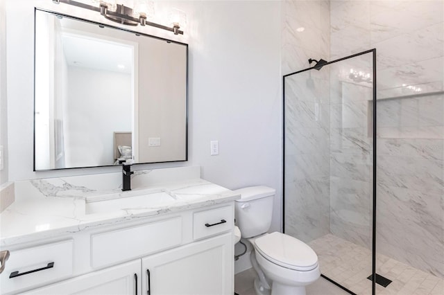 full bathroom with a stall shower, vanity, and toilet