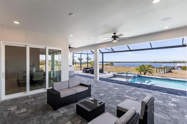 view of patio / terrace with glass enclosure, outdoor lounge area, a water view, and a pool with connected hot tub