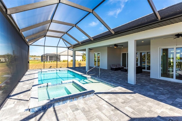 view of pool with a lanai, a pool with connected hot tub, a ceiling fan, and a patio