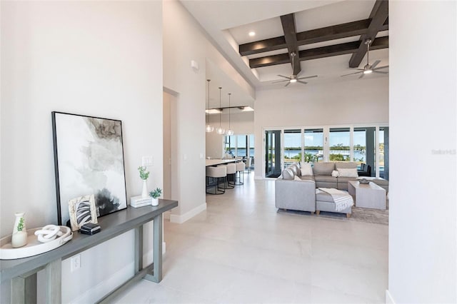 hall featuring recessed lighting, coffered ceiling, a towering ceiling, baseboards, and beam ceiling