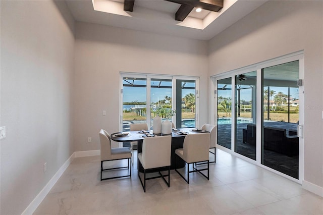 dining space featuring coffered ceiling, beam ceiling, a high ceiling, and baseboards