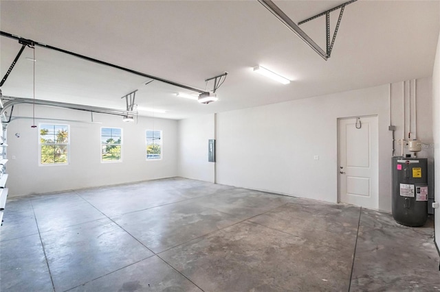 garage featuring a garage door opener, electric panel, and electric water heater