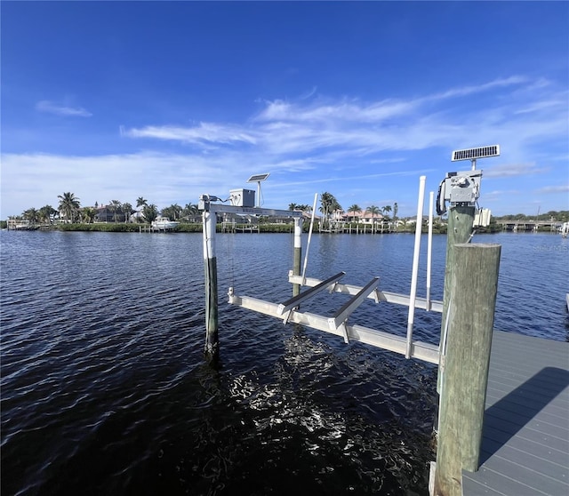 view of dock featuring a water view and boat lift