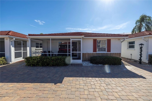 view of front of property featuring a sunroom