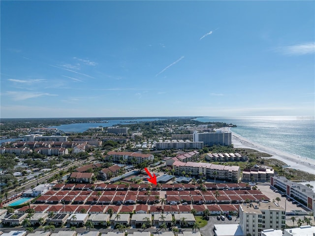 aerial view with a water view and a beach view