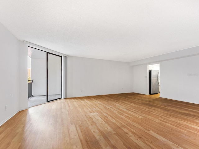 empty room with light wood-type flooring