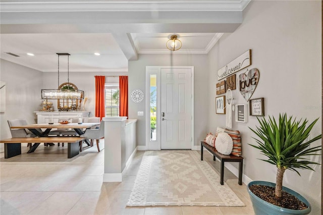 tiled foyer featuring ornamental molding