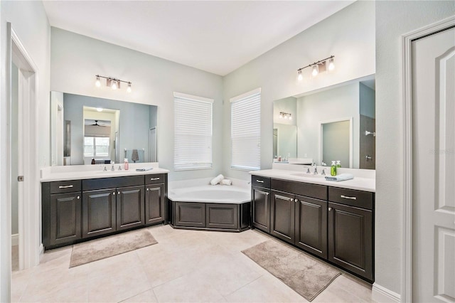 bathroom with vanity, a washtub, and tile patterned flooring