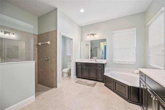 full bathroom with vanity, tile patterned flooring, shower with separate bathtub, and toilet