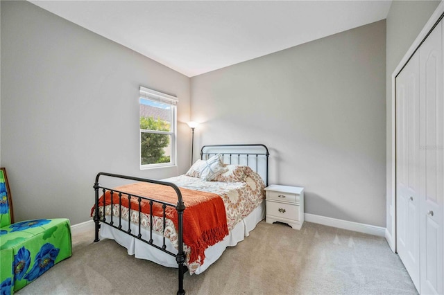 bedroom featuring a closet and light carpet