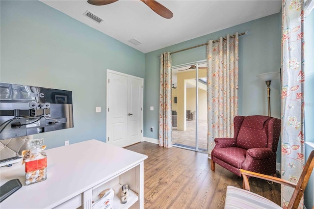 home office with hardwood / wood-style flooring and ceiling fan