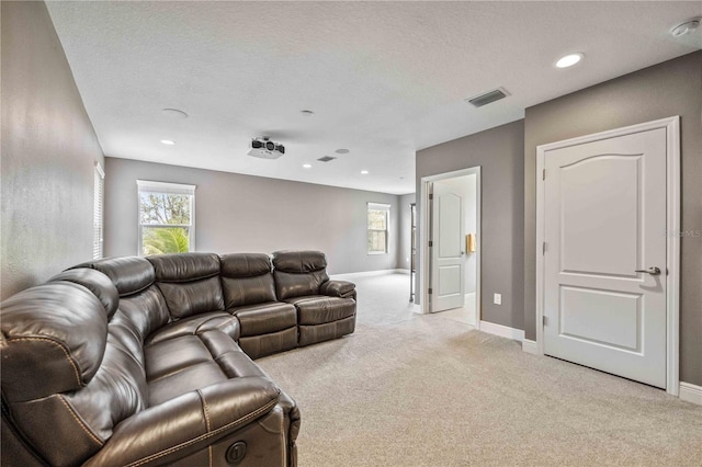 carpeted living room with a textured ceiling