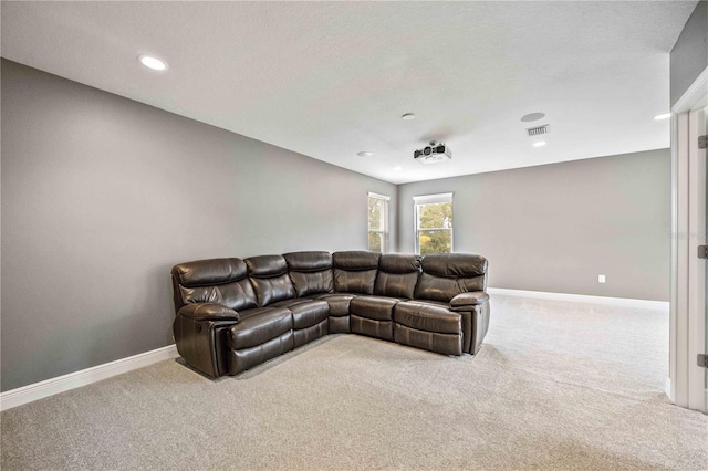 carpeted living room featuring a textured ceiling