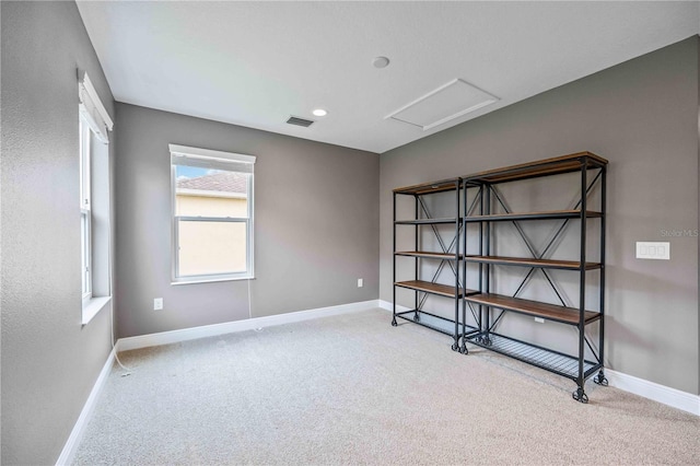 unfurnished room featuring light carpet