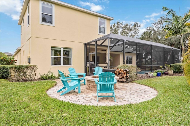 back of property featuring a fire pit, a patio area, a lawn, and a lanai