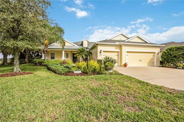 view of front of property featuring a garage and a front yard