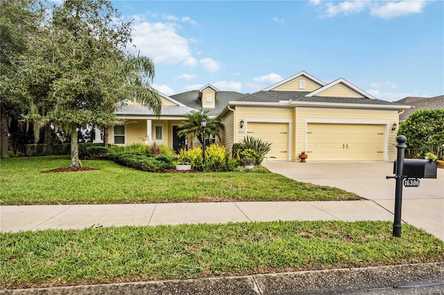 view of front of home with a garage and a front yard