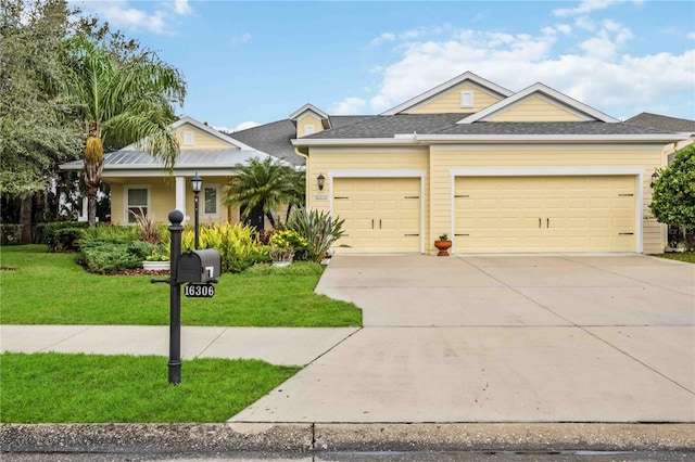 view of front of house featuring a garage and a front lawn