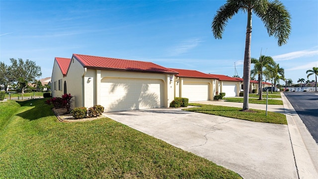 view of front of property with a front lawn and a garage