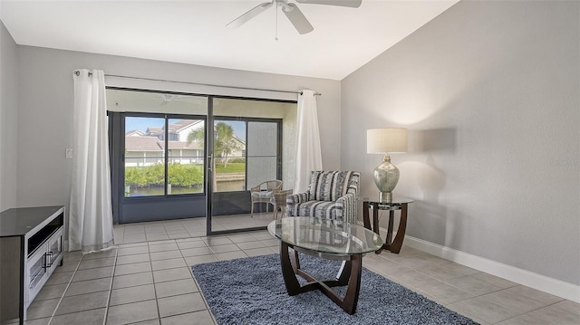 living area with light tile flooring, ceiling fan, and lofted ceiling