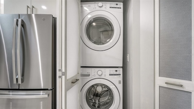 laundry area featuring stacked washer / drying machine