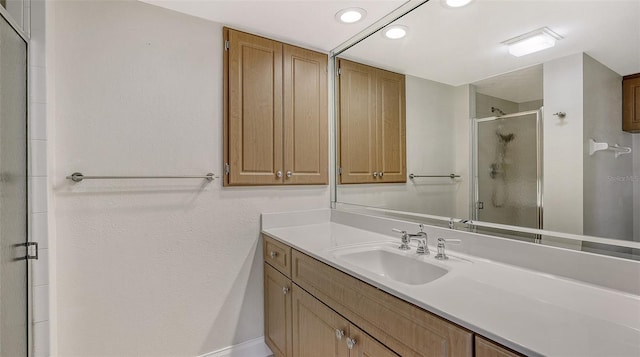 bathroom featuring an enclosed shower and vanity