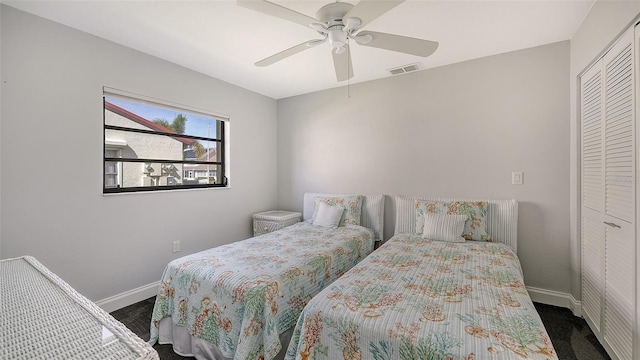 carpeted bedroom featuring a closet and ceiling fan