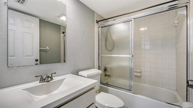 full bathroom with toilet, combined bath / shower with glass door, and vanity