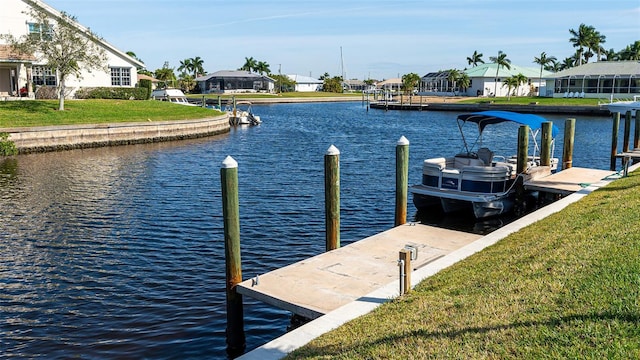 dock area featuring a water view and a lawn