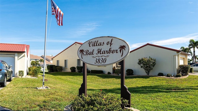 community / neighborhood sign featuring a yard