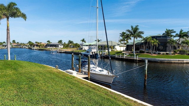 view of dock featuring a water view, a lanai, and a yard