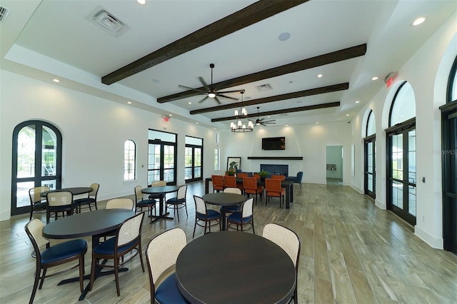 dining room with french doors, light hardwood / wood-style flooring, ceiling fan, and a wealth of natural light