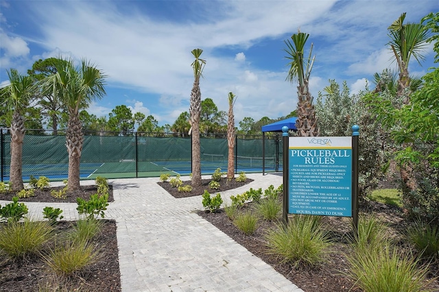 view of property's community featuring tennis court