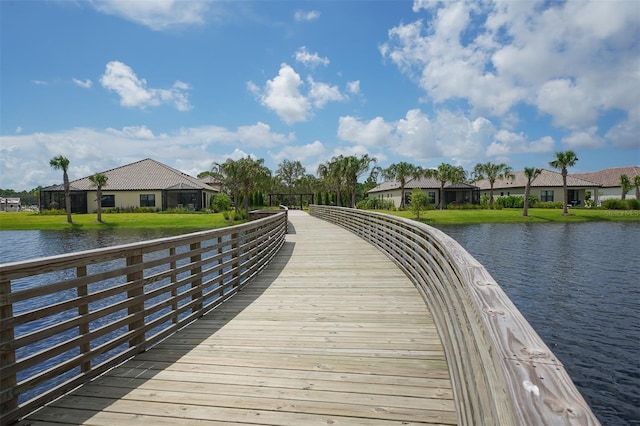 dock area featuring a water view and a yard