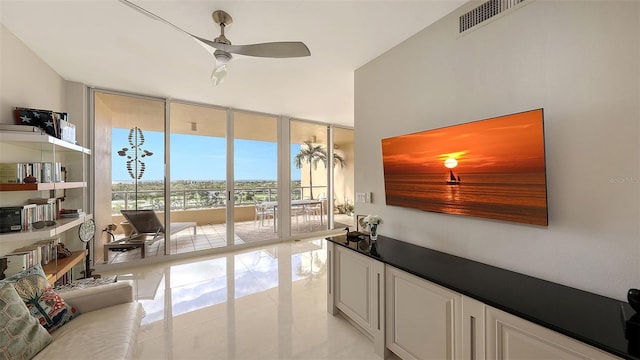 living room featuring floor to ceiling windows and ceiling fan