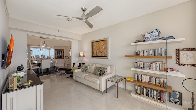 living room featuring ceiling fan with notable chandelier