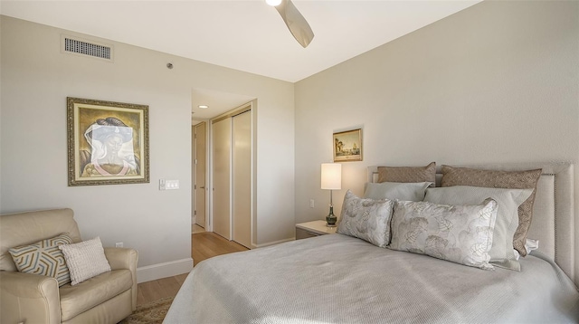 bedroom with ceiling fan, a closet, and light wood-type flooring