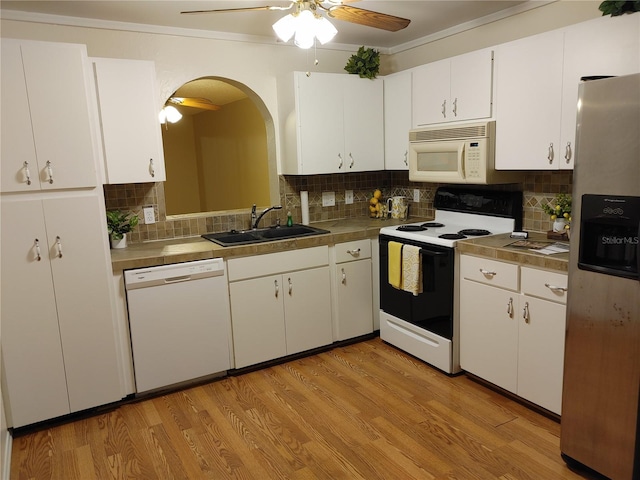 kitchen featuring white cabinetry, decorative backsplash, ceiling fan, and white appliances