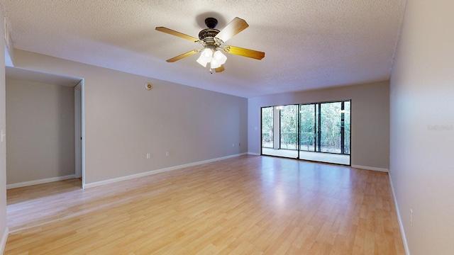 empty room with a textured ceiling, ceiling fan, and light wood-type flooring