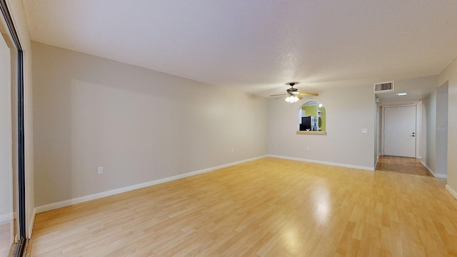 unfurnished living room with light hardwood / wood-style flooring and ceiling fan