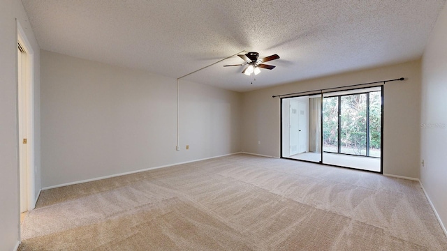 unfurnished room with light colored carpet, a textured ceiling, and ceiling fan