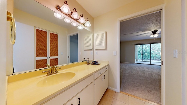 bathroom featuring vanity, a textured ceiling, ceiling fan, and tile patterned flooring