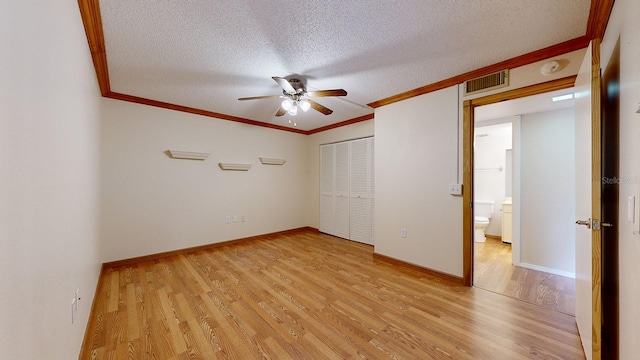 unfurnished bedroom featuring ceiling fan, a textured ceiling, a closet, and light hardwood / wood-style floors