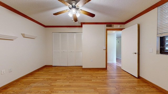 unfurnished bedroom with a closet, a textured ceiling, ceiling fan, and light wood-type flooring