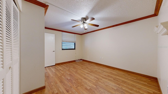 unfurnished room with crown molding, a textured ceiling, ceiling fan, and light hardwood / wood-style floors